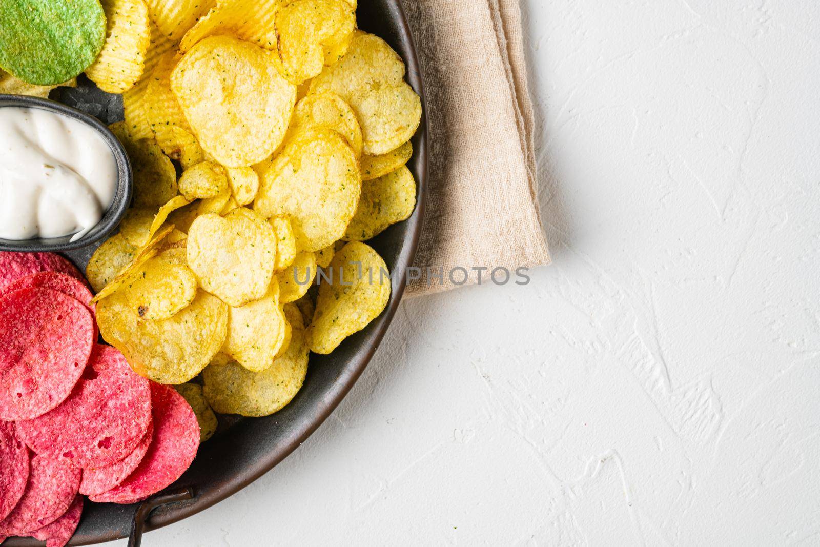 Variation different potato chips, on white stone table background, top view flat lay, with copy space for text