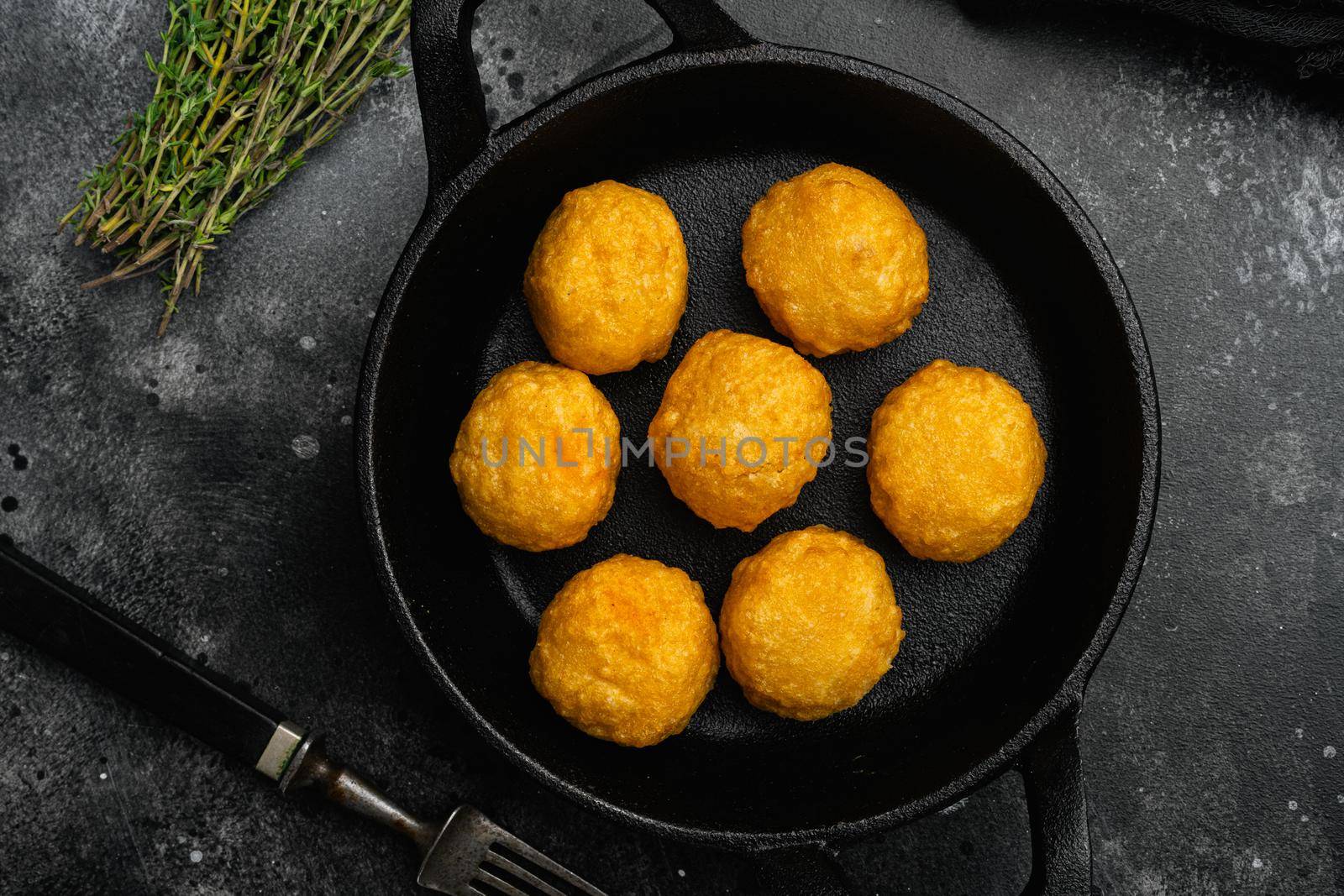 Battered sausage meat ball on black dark stone table background, top view flat lay by Ilianesolenyi