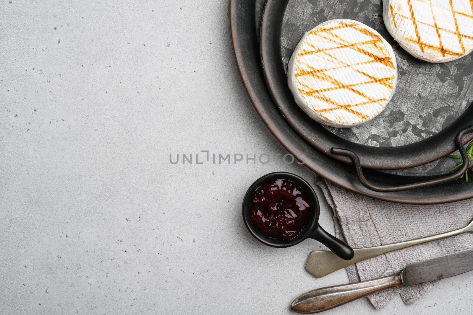 Baked Camembert cheese on gray stone table background, top view flat lay, with copy space for text by Ilianesolenyi