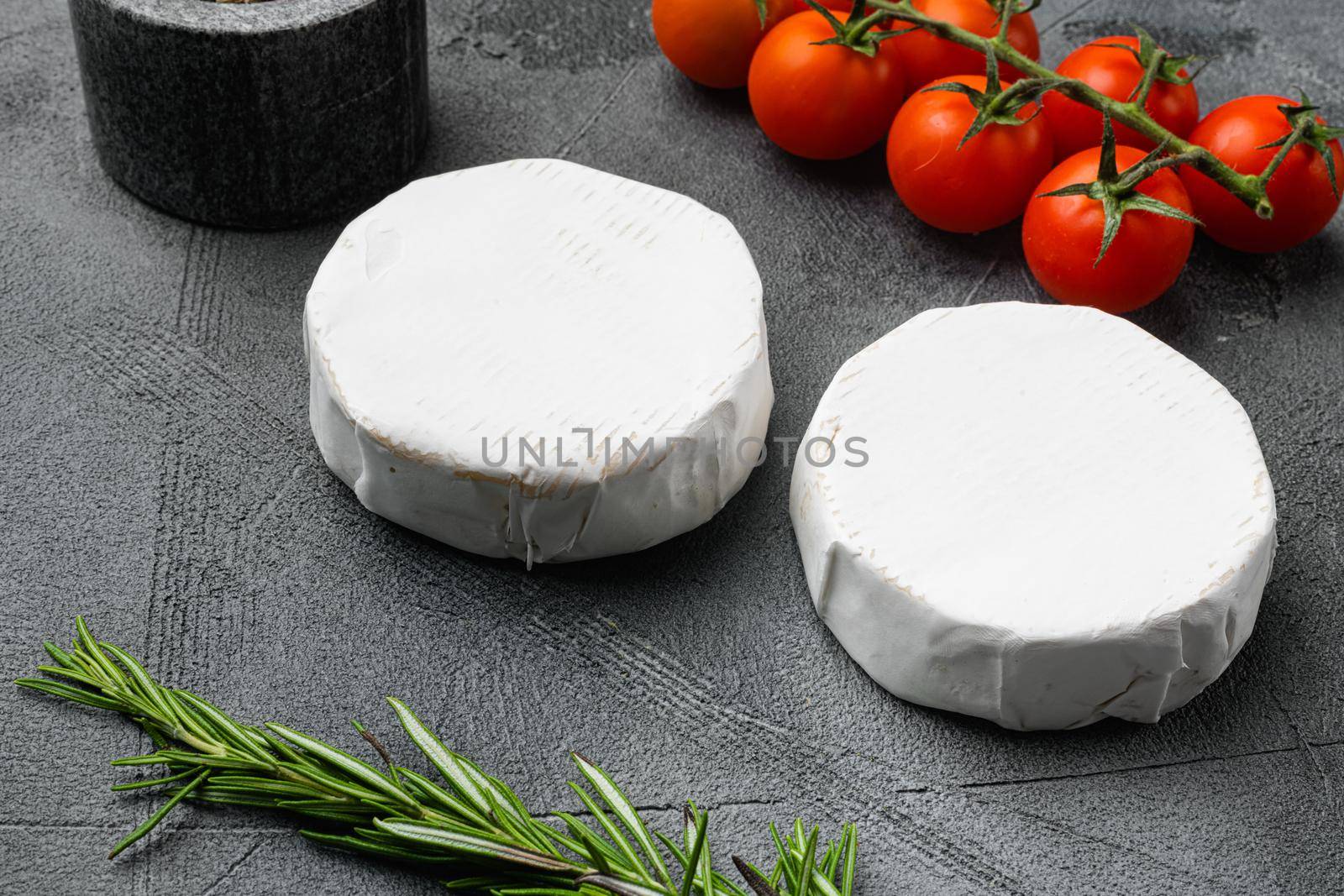 Creamy Brie cheese on gray stone table background by Ilianesolenyi