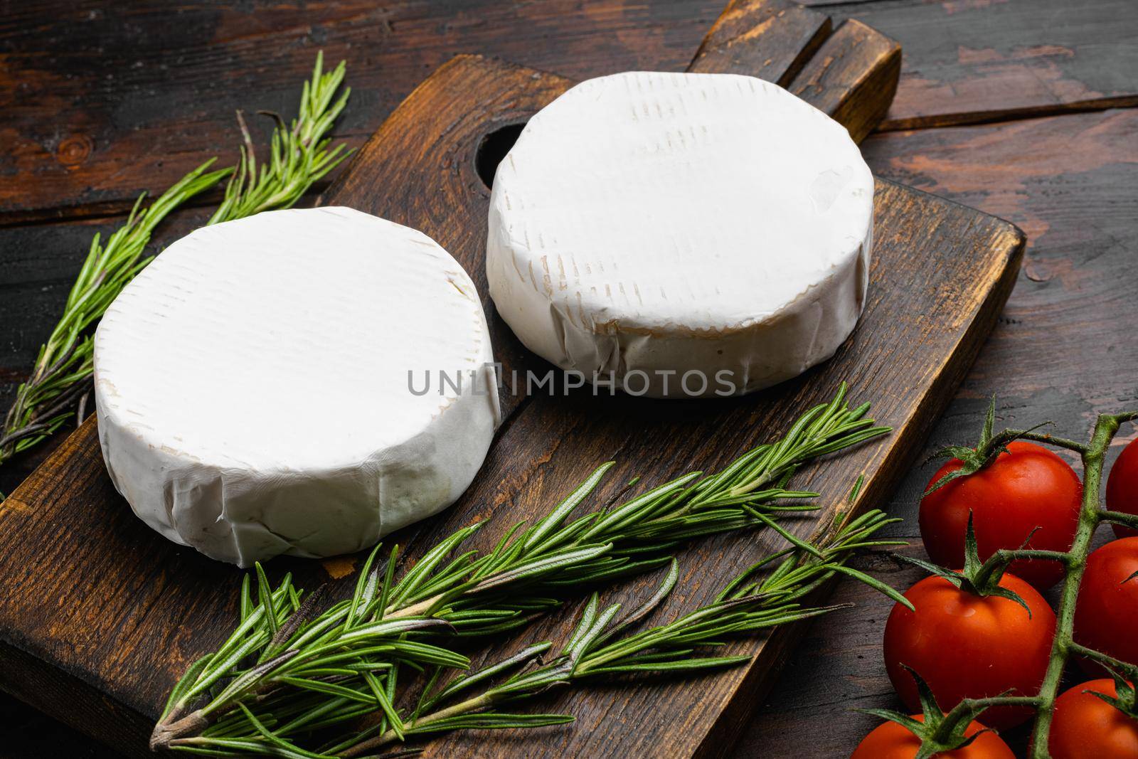 Creamy Brie cheese on old dark wooden table background by Ilianesolenyi
