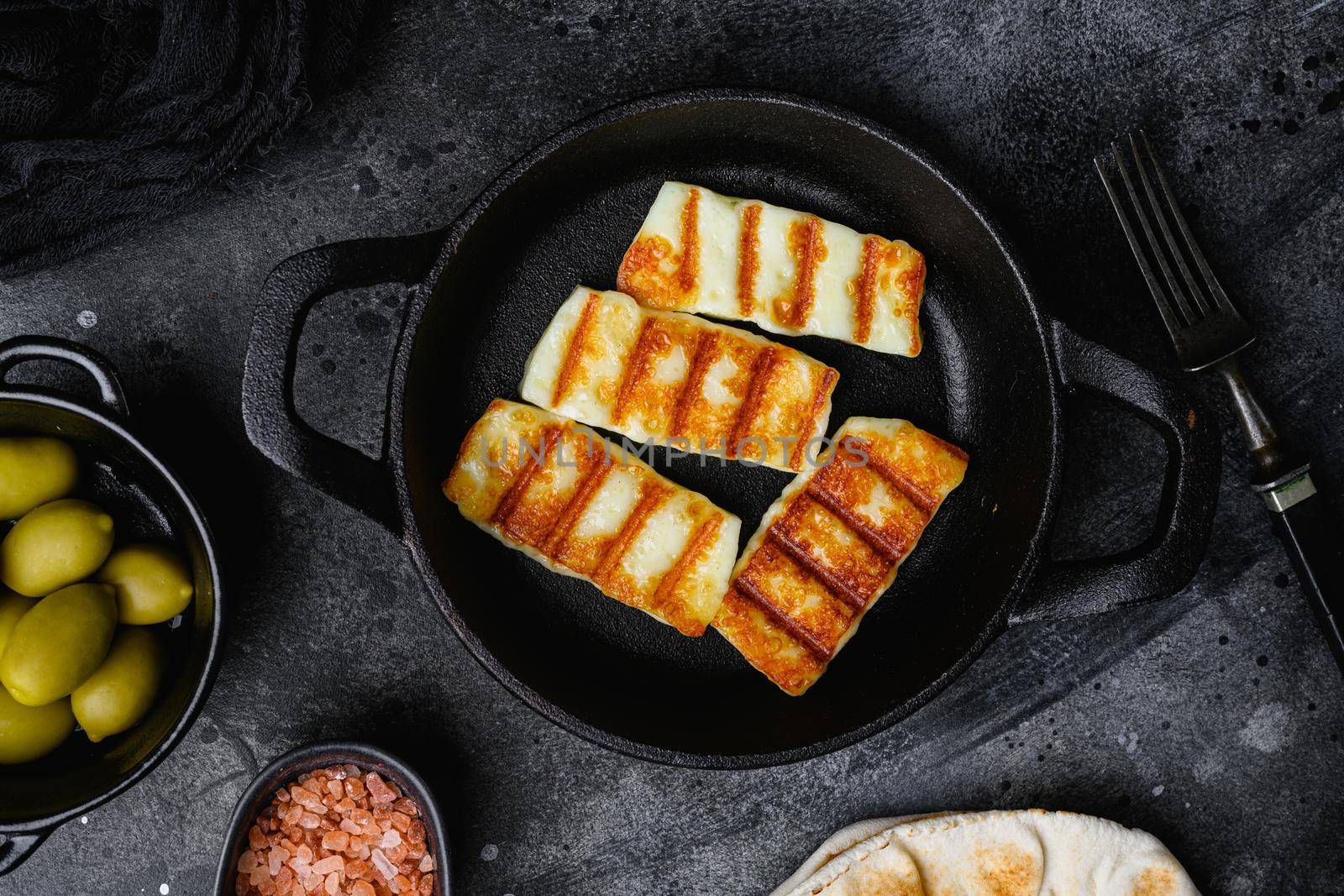 Halloumi fried cheese, on black dark stone table background, top view flat lay by Ilianesolenyi