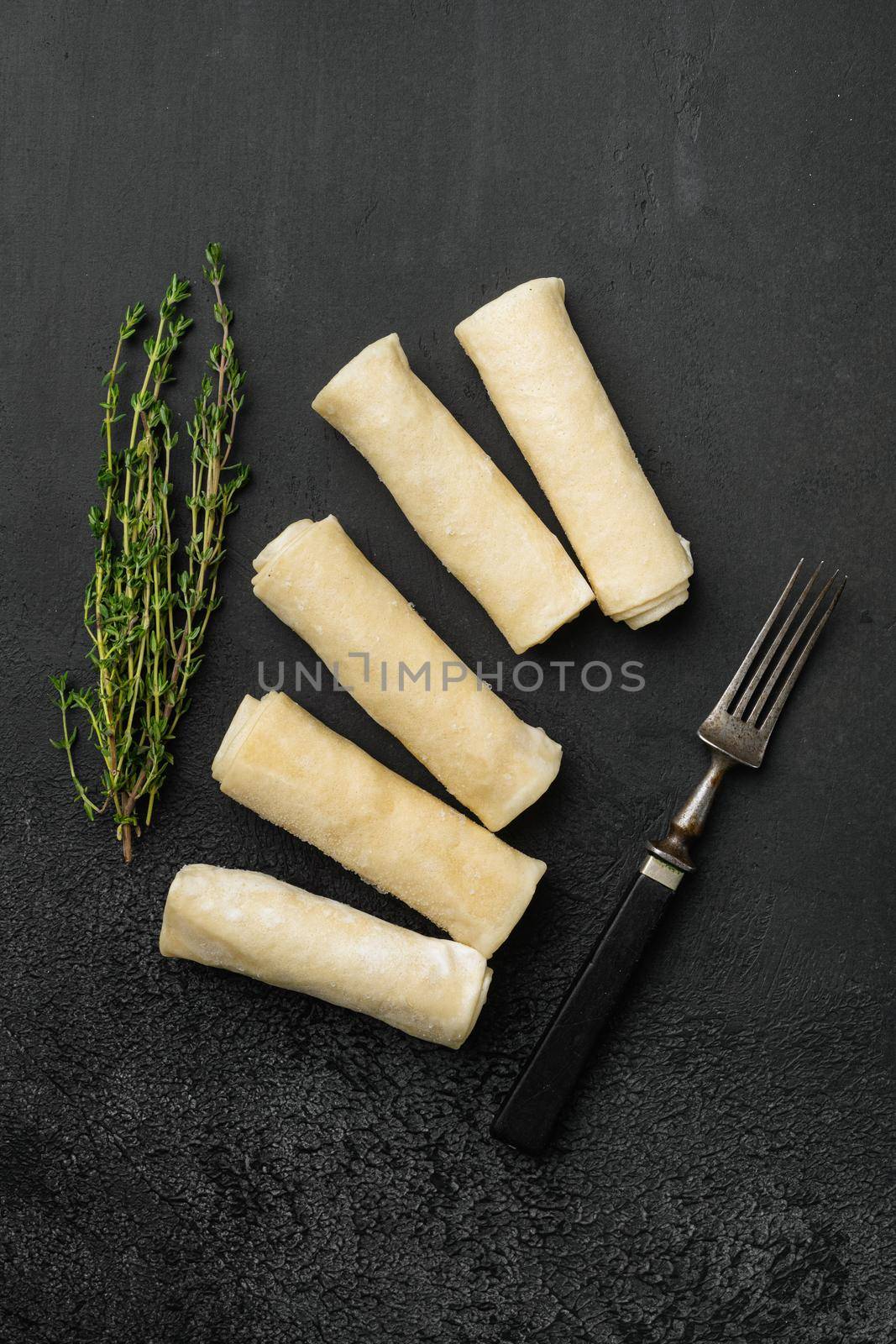 Frozen pancake on black dark stone table background, top view flat lay by Ilianesolenyi