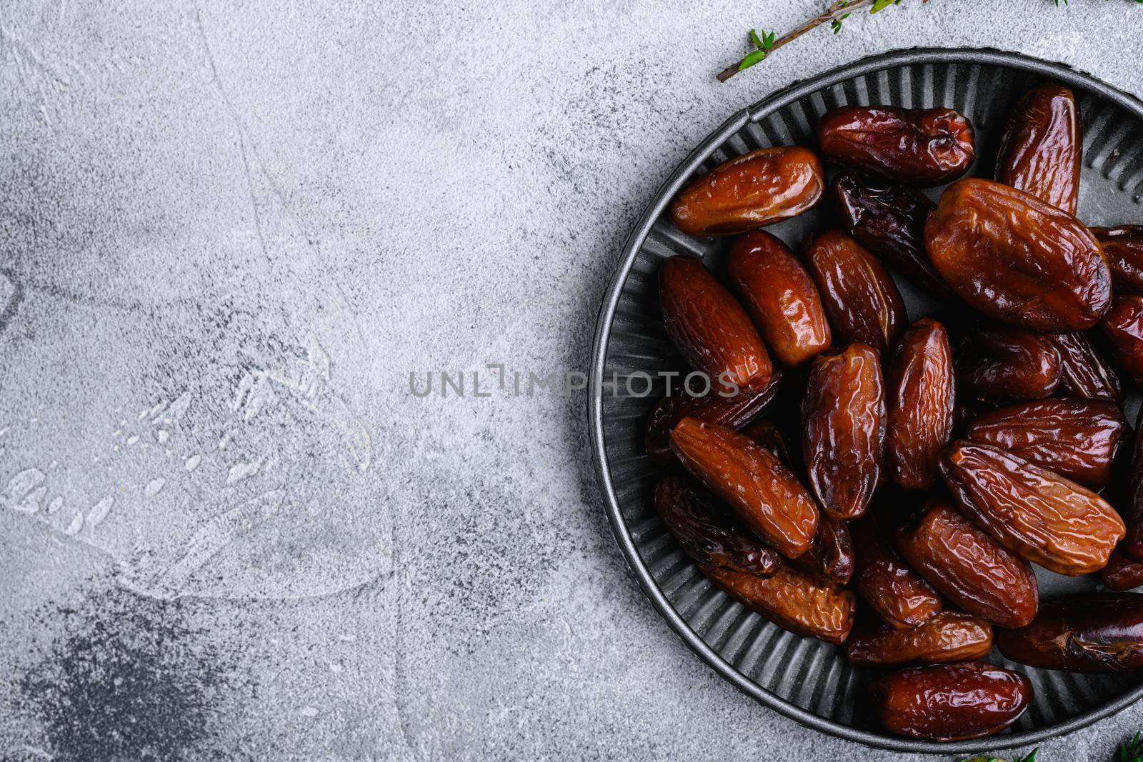 Traditional arabic dry dates set, on gray stone table background, top view flat lay, with copy space for text by Ilianesolenyi