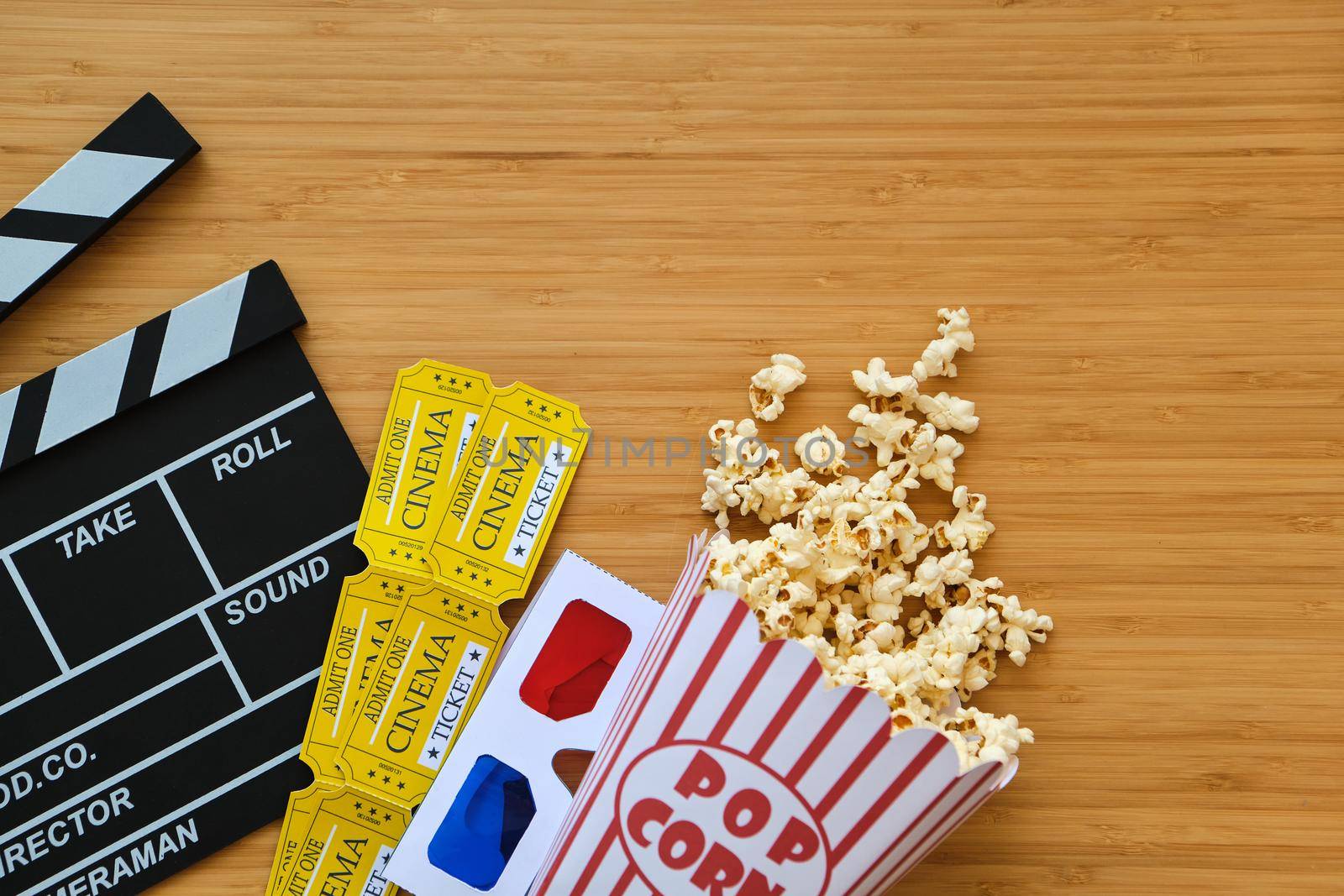 clapper board, movies tickets and popcorn. Movie top view on red background with copy space