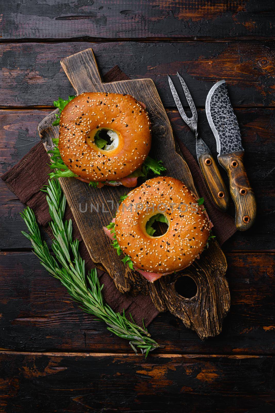 Cream cheese and smoked salmon bagel set, on old dark wooden table background, top view flat lay