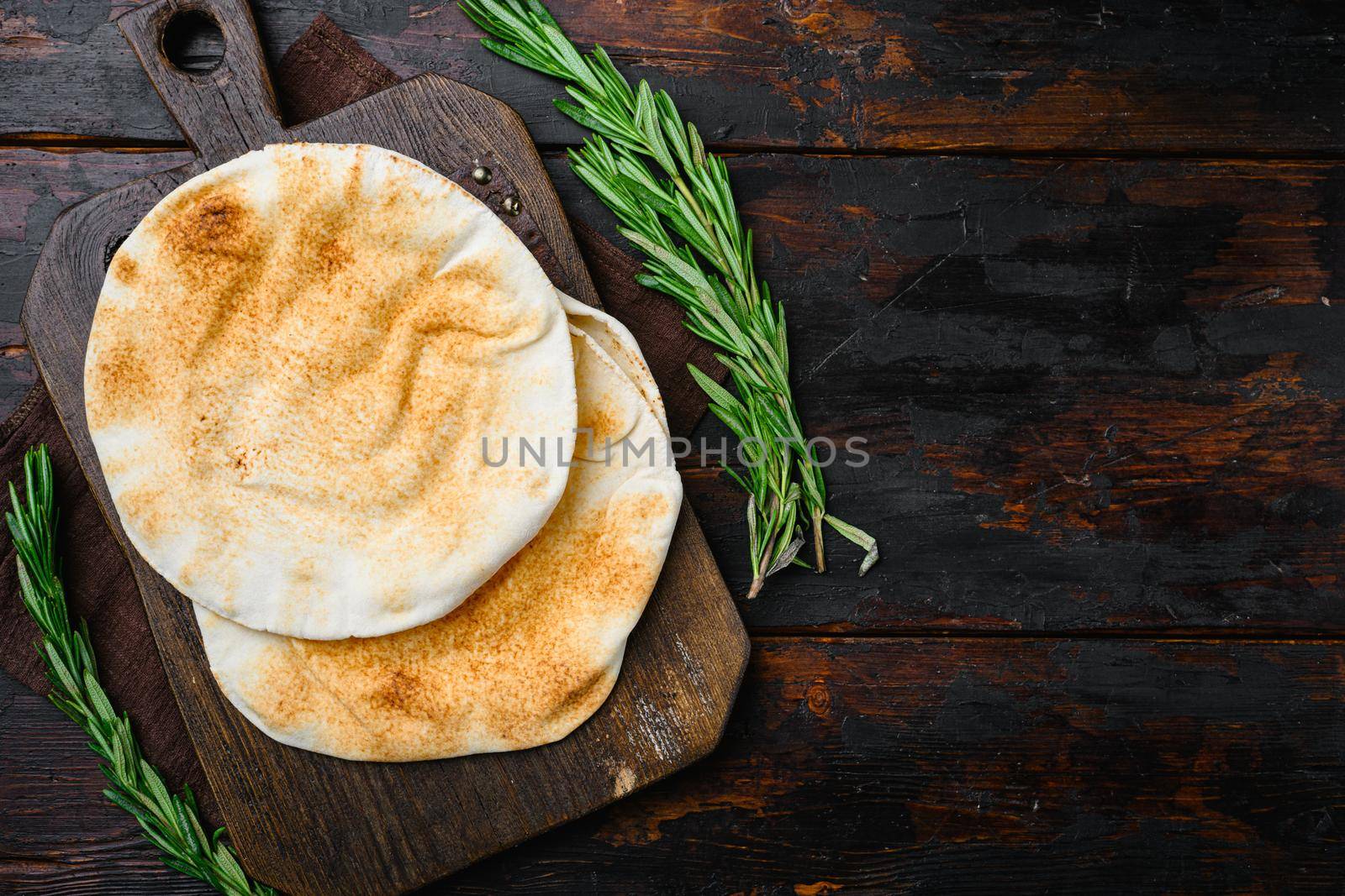 Pita flat bread set, on old dark wooden table background, top view flat lay, with copy space for text by Ilianesolenyi