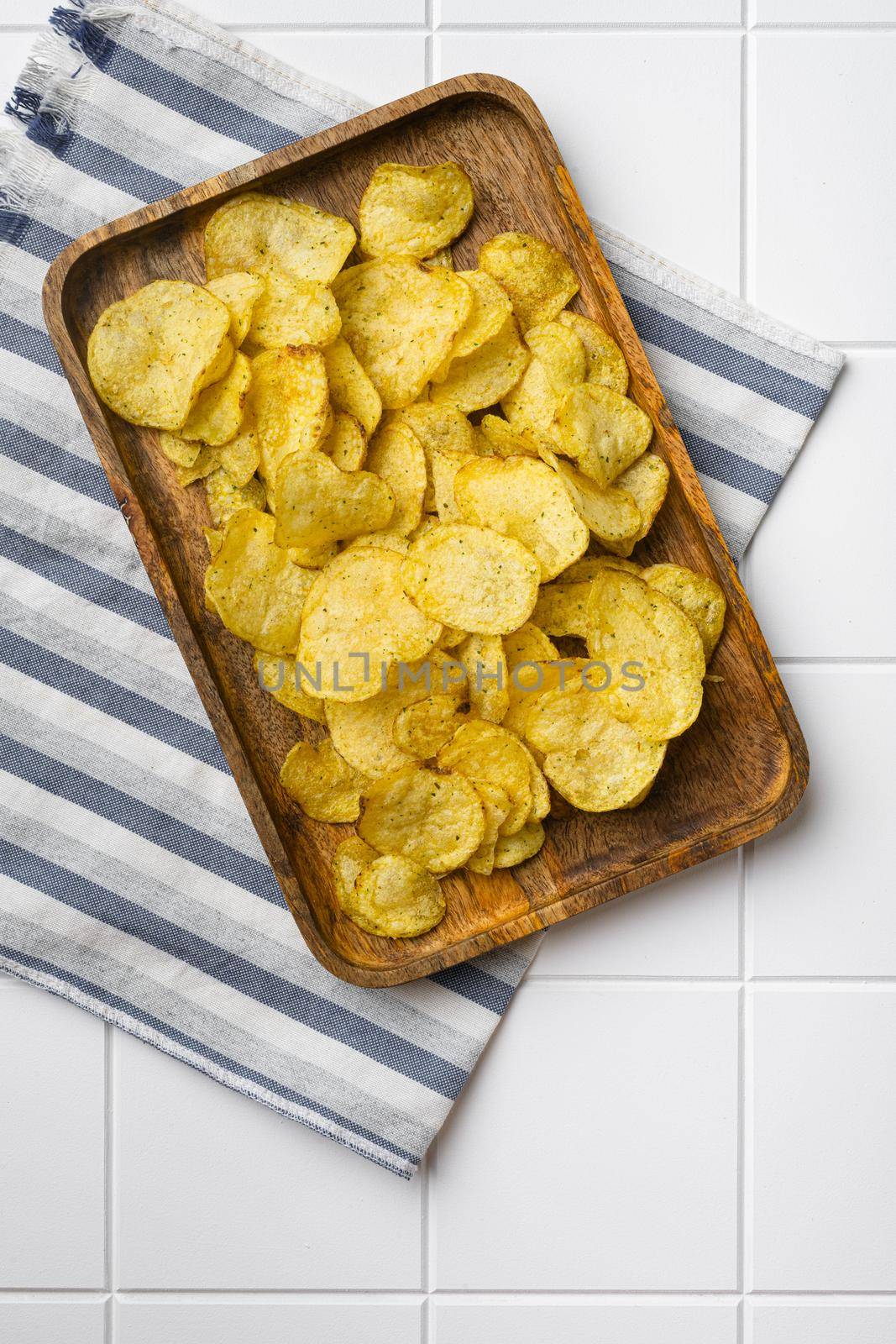 Root Classic potato chips, on white ceramic squared tile table background, top view flat lay