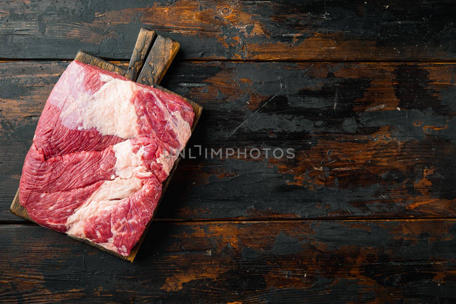Raw brisket beef cut. Black Angus beef set, on old dark wooden table background, top view flat lay, with copy space for text