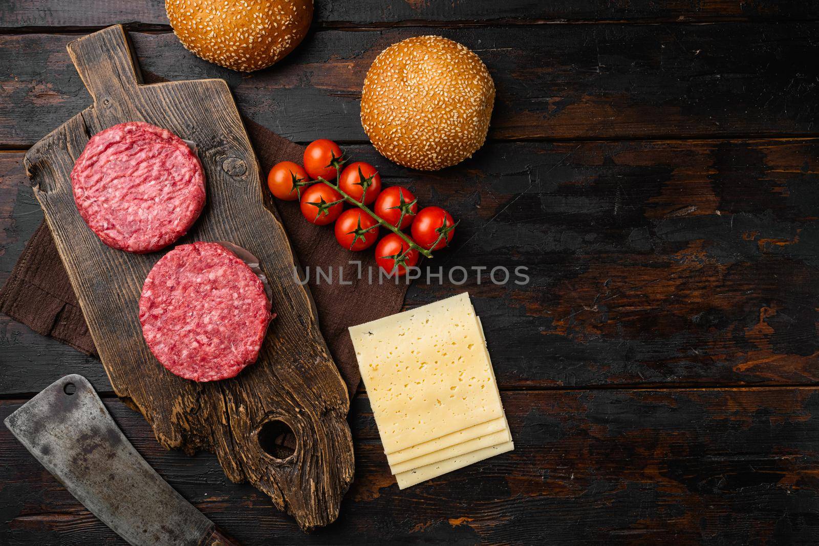 Fresh Raw Minced Homemade Grill Beef Steak Burgers, on old dark wooden table background, top view flat lay, with copy space for text