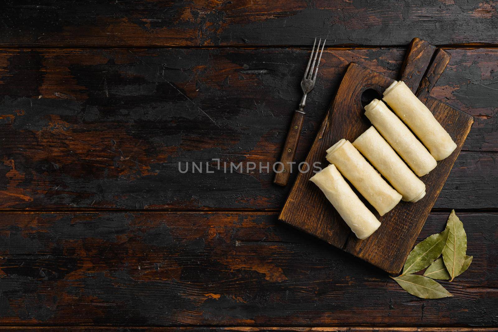 Semi finished pancakes, on old dark wooden table background, top view flat lay, with copy space for text