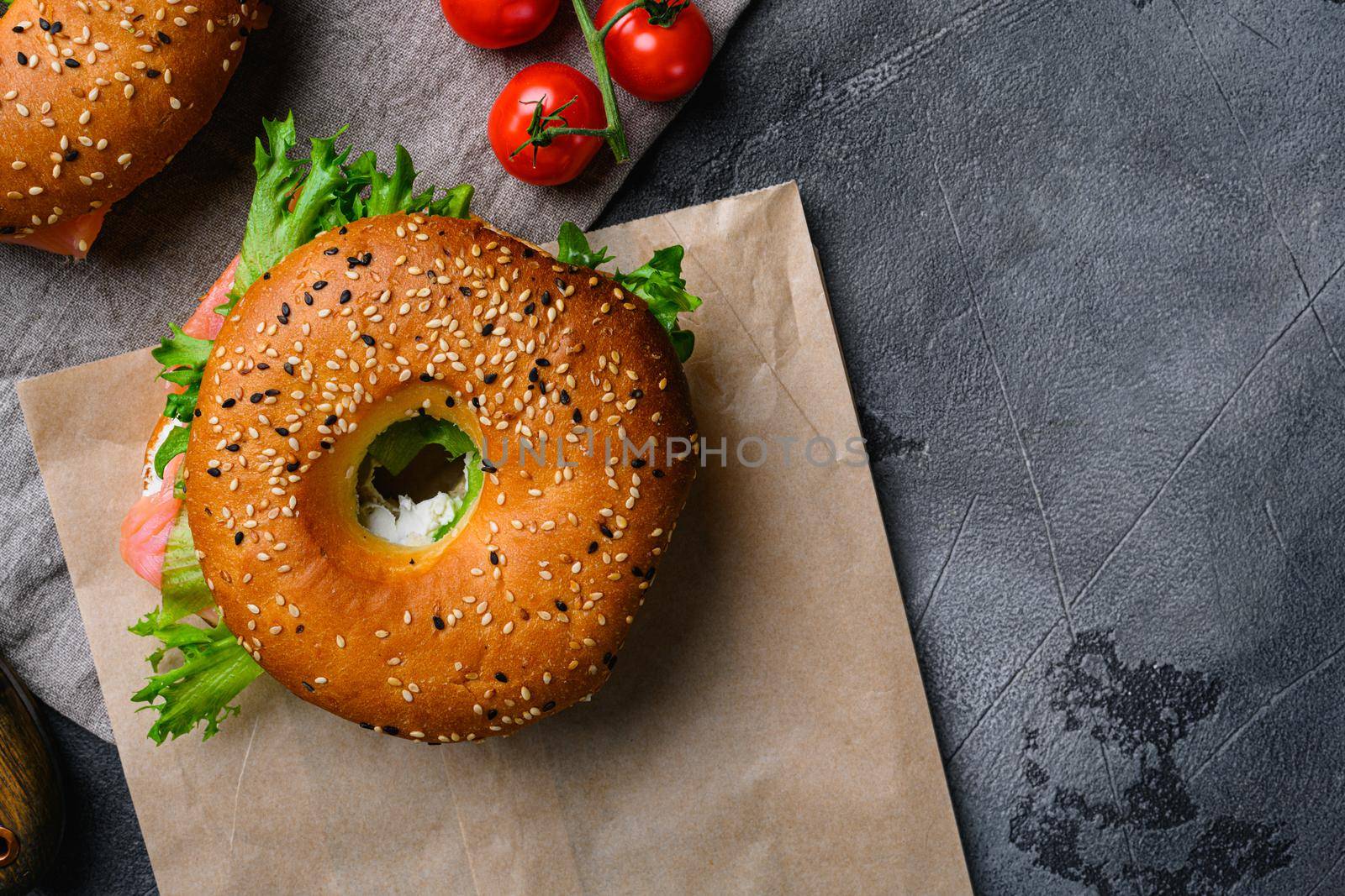 Bagel with red fish and soft cheese set, on gray stone table background, top view flat lay, with copy space for text