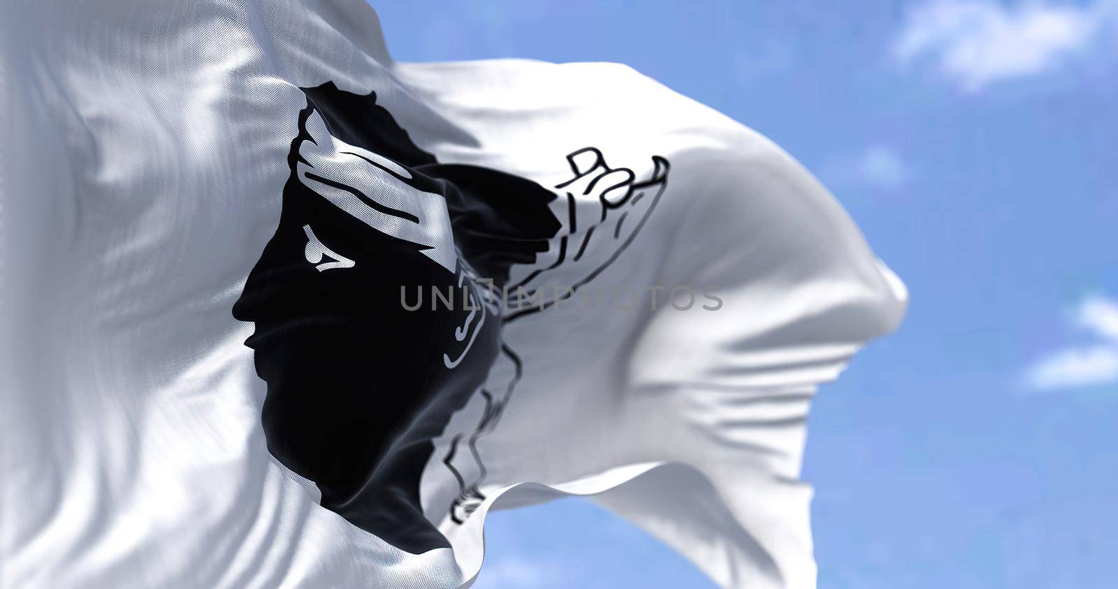 The flag of Corsica waving in the wind on a clear day by rarrarorro