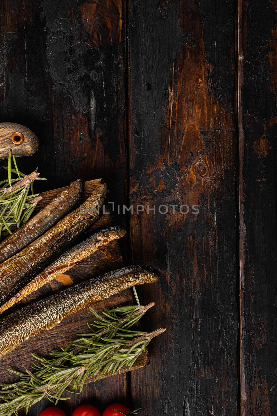 Fried river lamprey , on old dark wooden table background, top view flat lay, with copy space for text by Ilianesolenyi