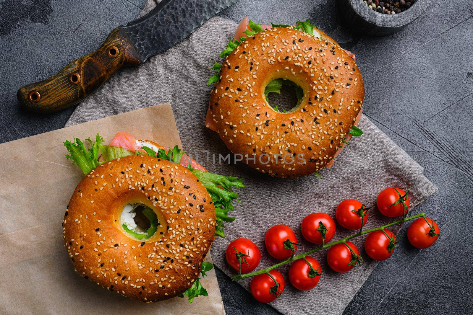Cream cheese and smoked salmon bagel, on gray stone table background, top view flat lay by Ilianesolenyi