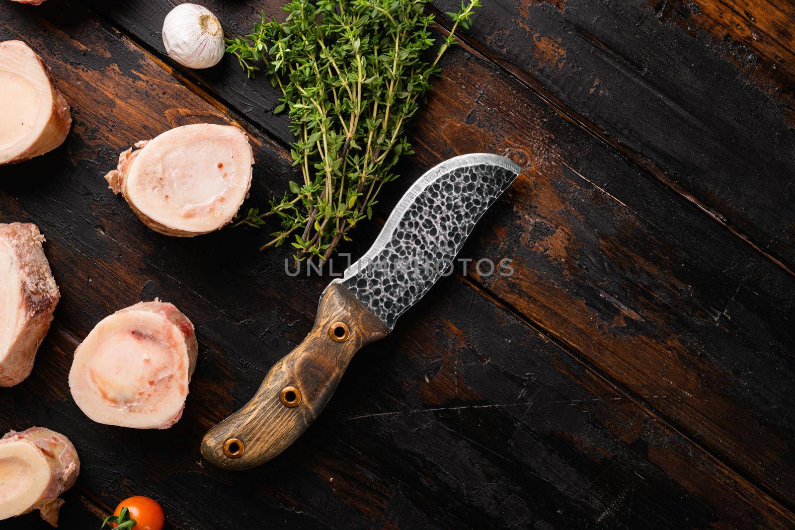 Raw Beef Bones for Making Broth at Home set, on old dark wooden table background, top view flat lay, with copy space for text