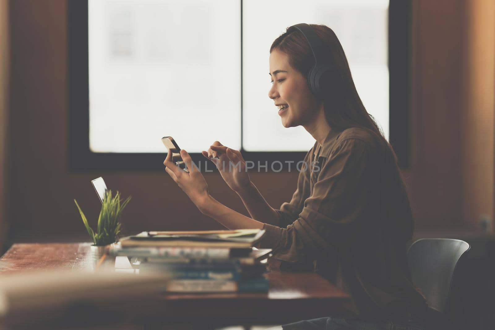 Young composer woman recording music lyrics her voice in to smartphone