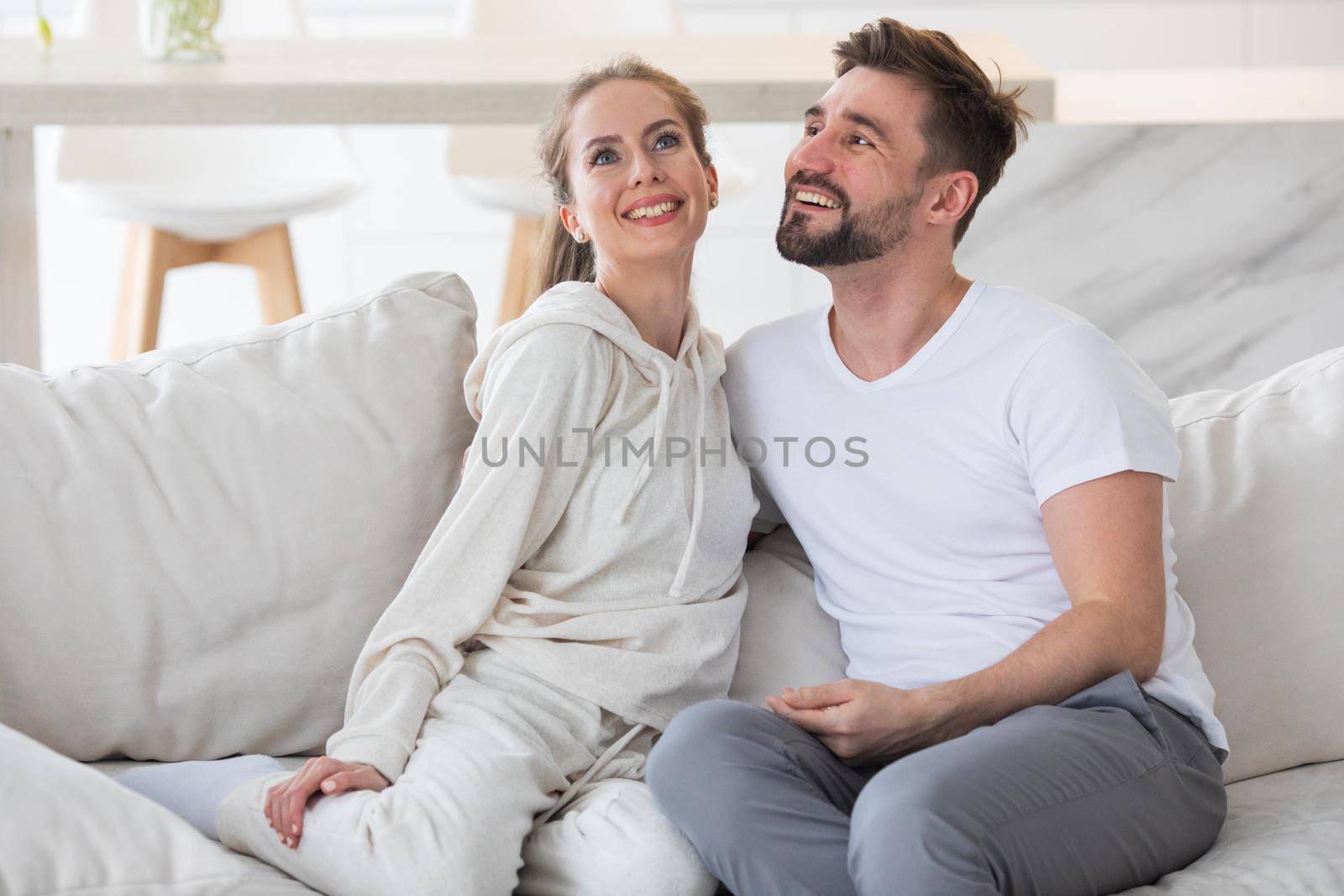 Couple relaxing in living room and smiling