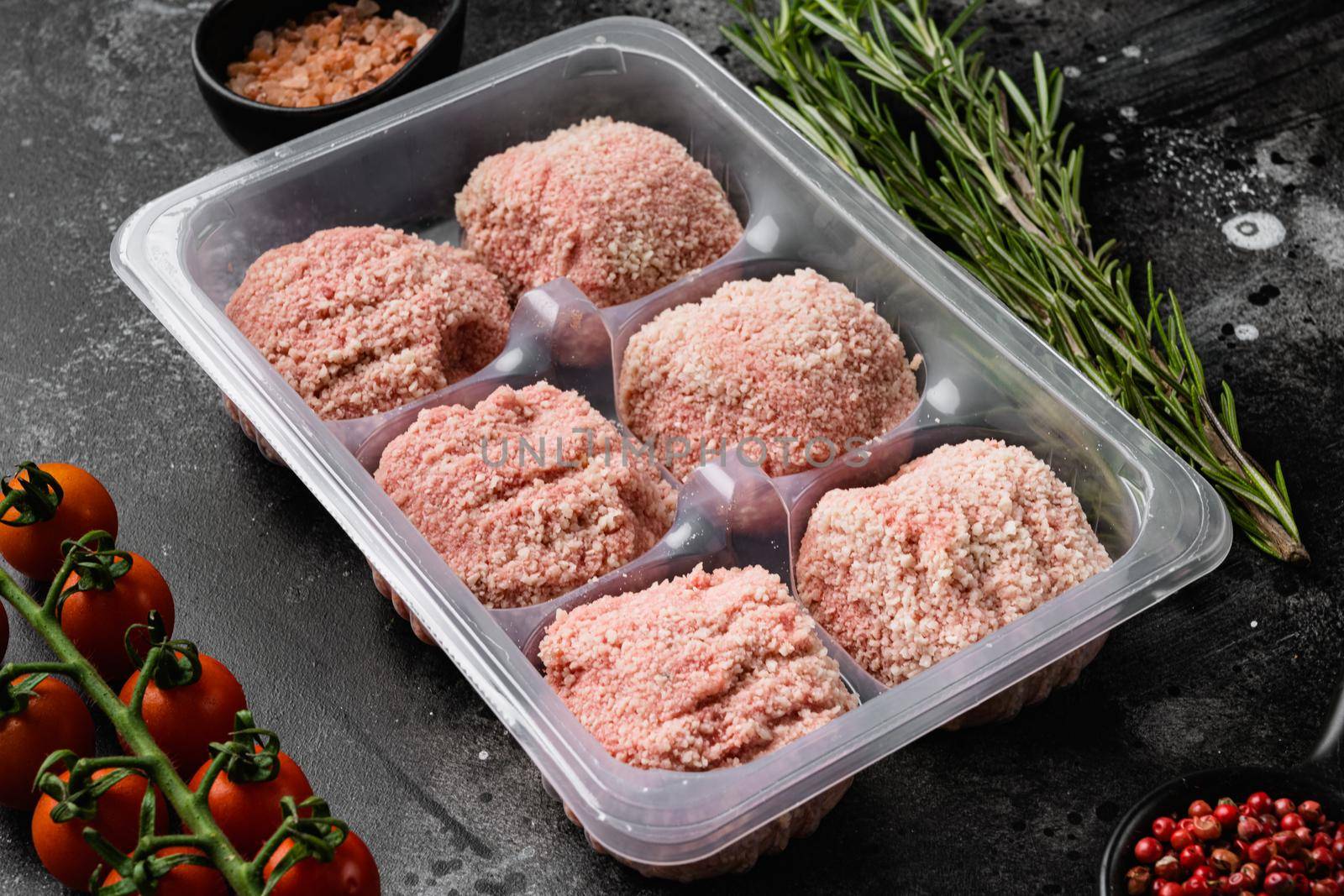 Chicken burgers in retail container set, on black dark stone table background
