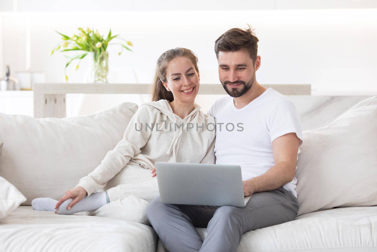 Happy married couple with laptop by ALotOfPeople