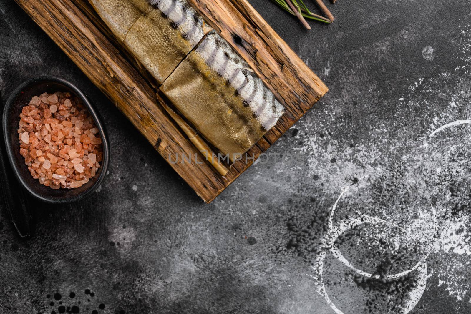 Smoked mackerel set, on black dark stone table background, top view flat lay, with copy space for text