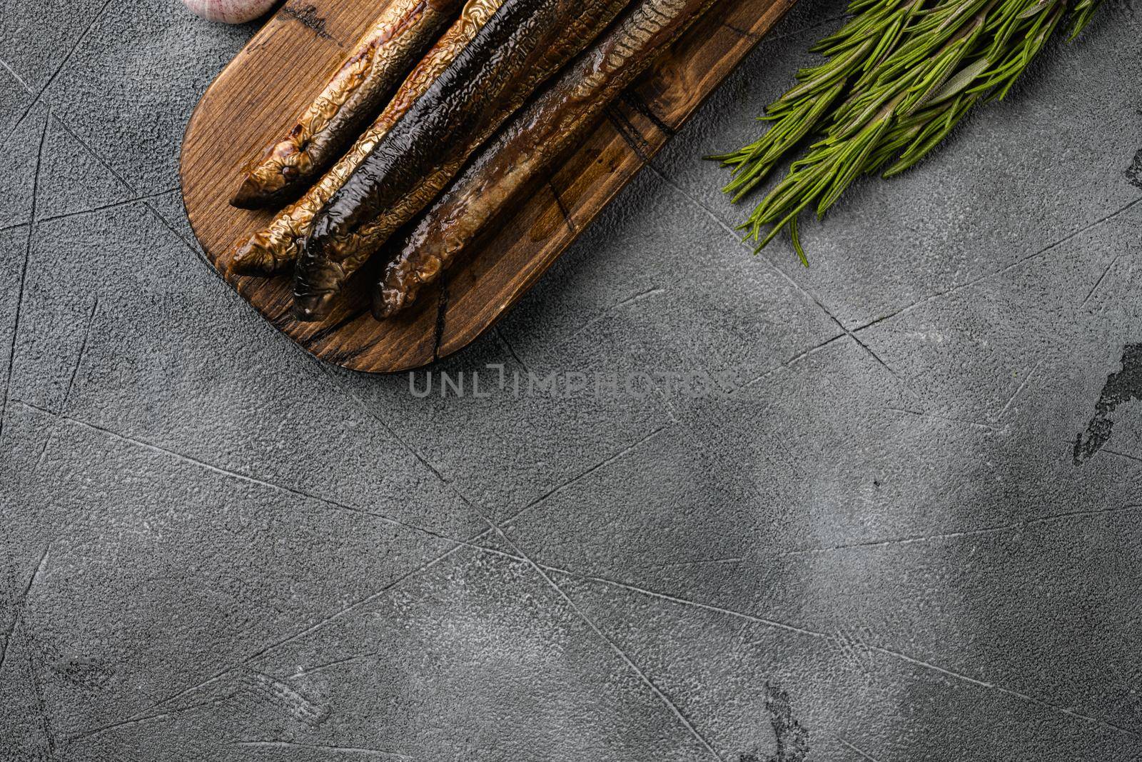 Fried river lamprey set, on gray stone table background, top view flat lay, with copy space for text