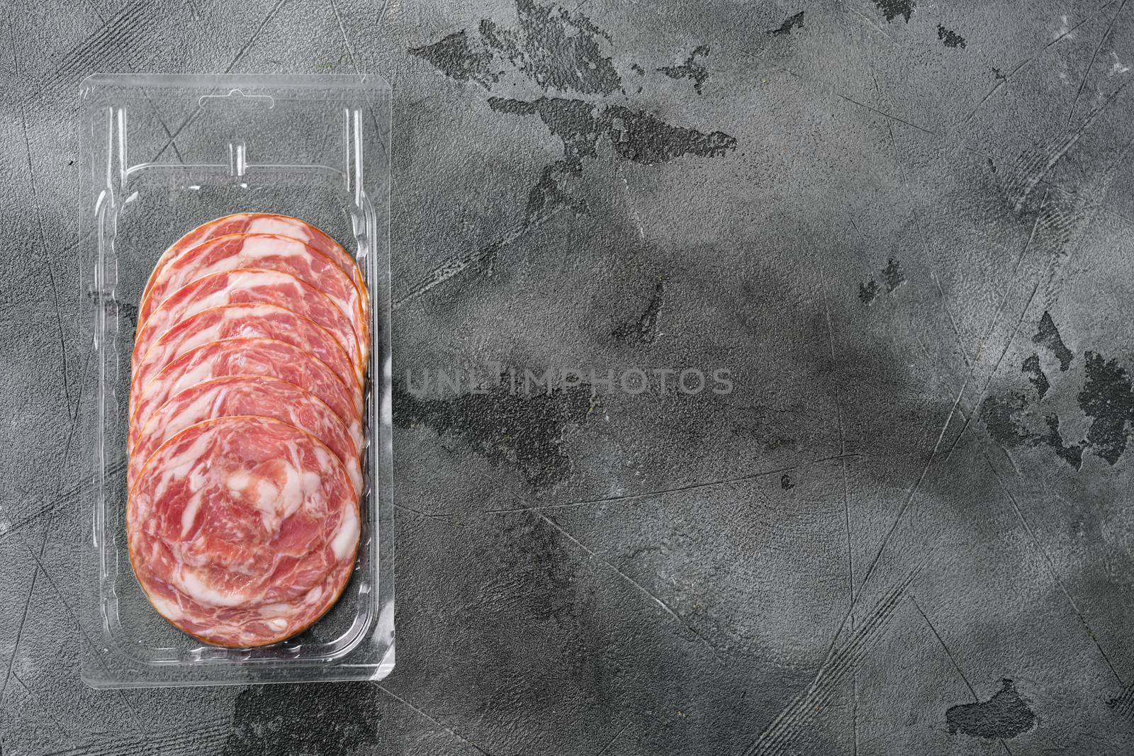 Dry smoked sausage pack set, on gray stone table background, top view flat lay, with copy space for text