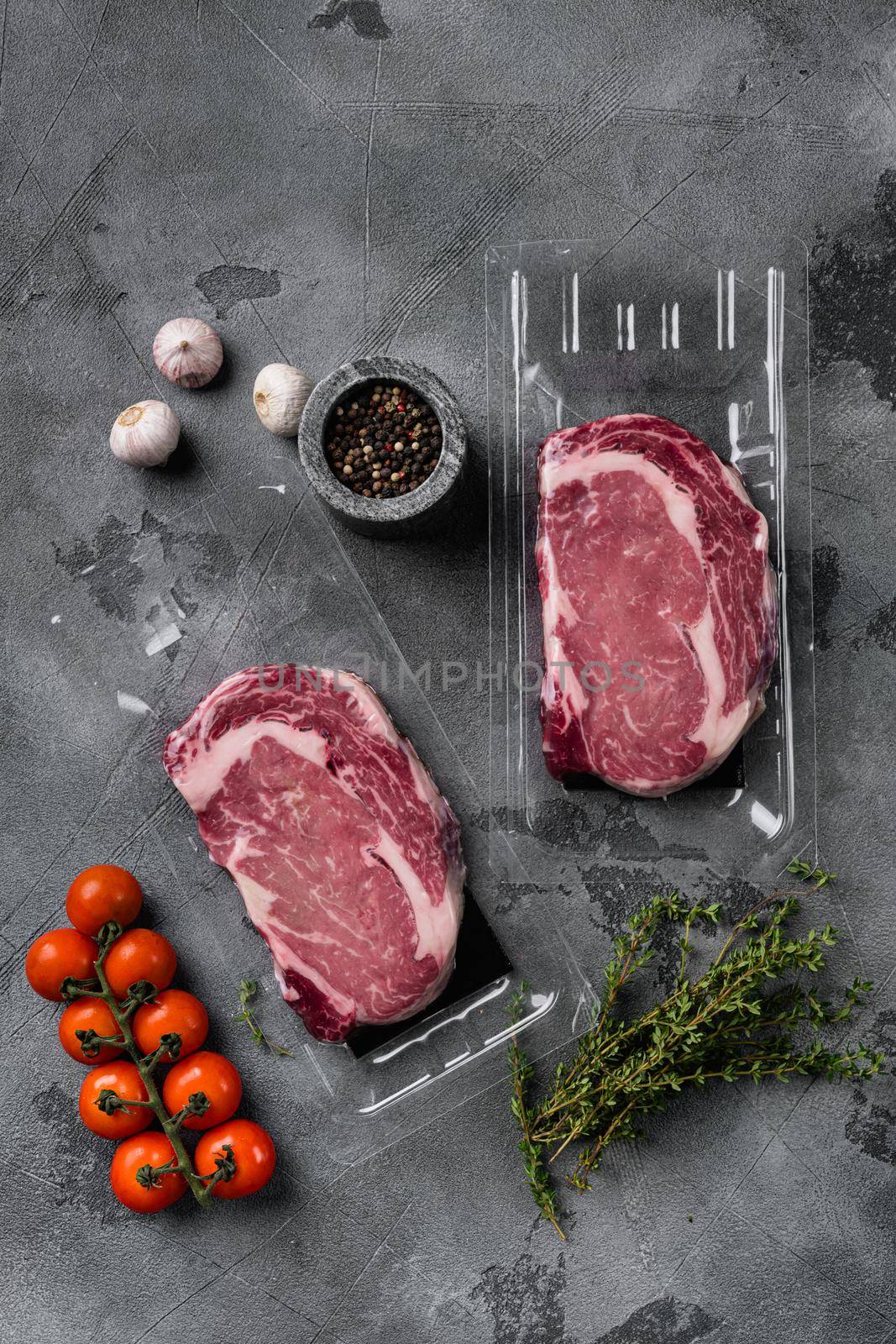 Steak, ribeye, vacuum packing set, on gray stone table background, top view flat lay