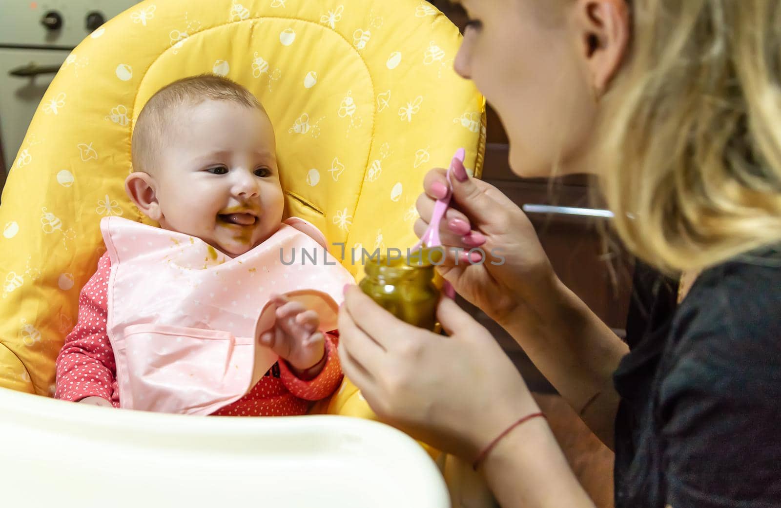 Mom feeds baby with vegetable puree. Selective focus. Food.