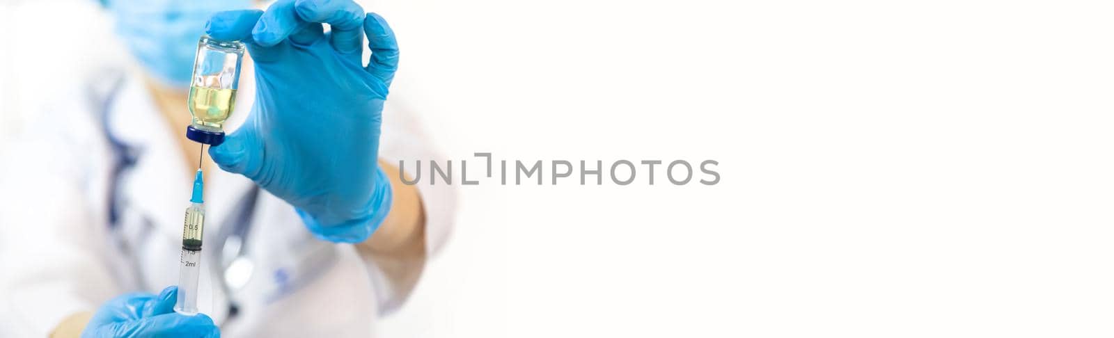 Doctor filling syringe with medication, closeup. Vaccination and immunization. Selective focus. by yanadjana