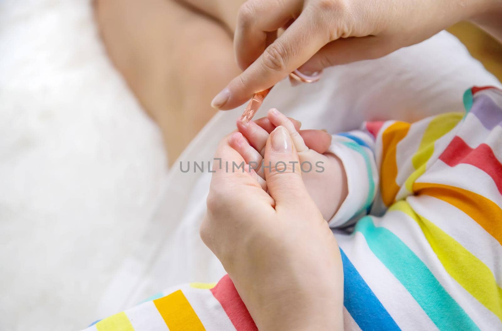 mother cuts little baby's nails. Selective focus. by yanadjana