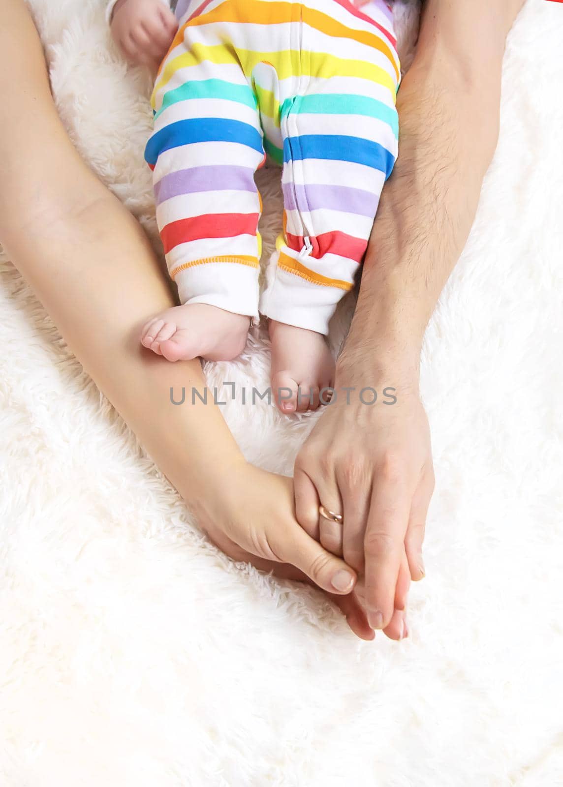 toddler and parents feet on the bed. Selective focus. child,