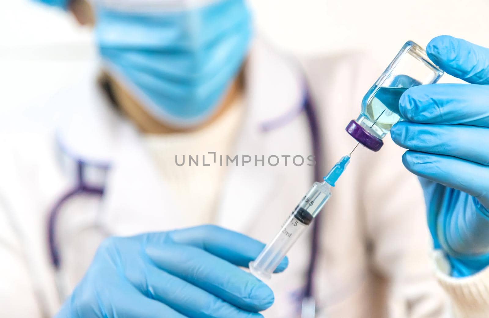 Doctor filling syringe with medication, closeup. Vaccination and immunization. Selective focus. Vaccine.