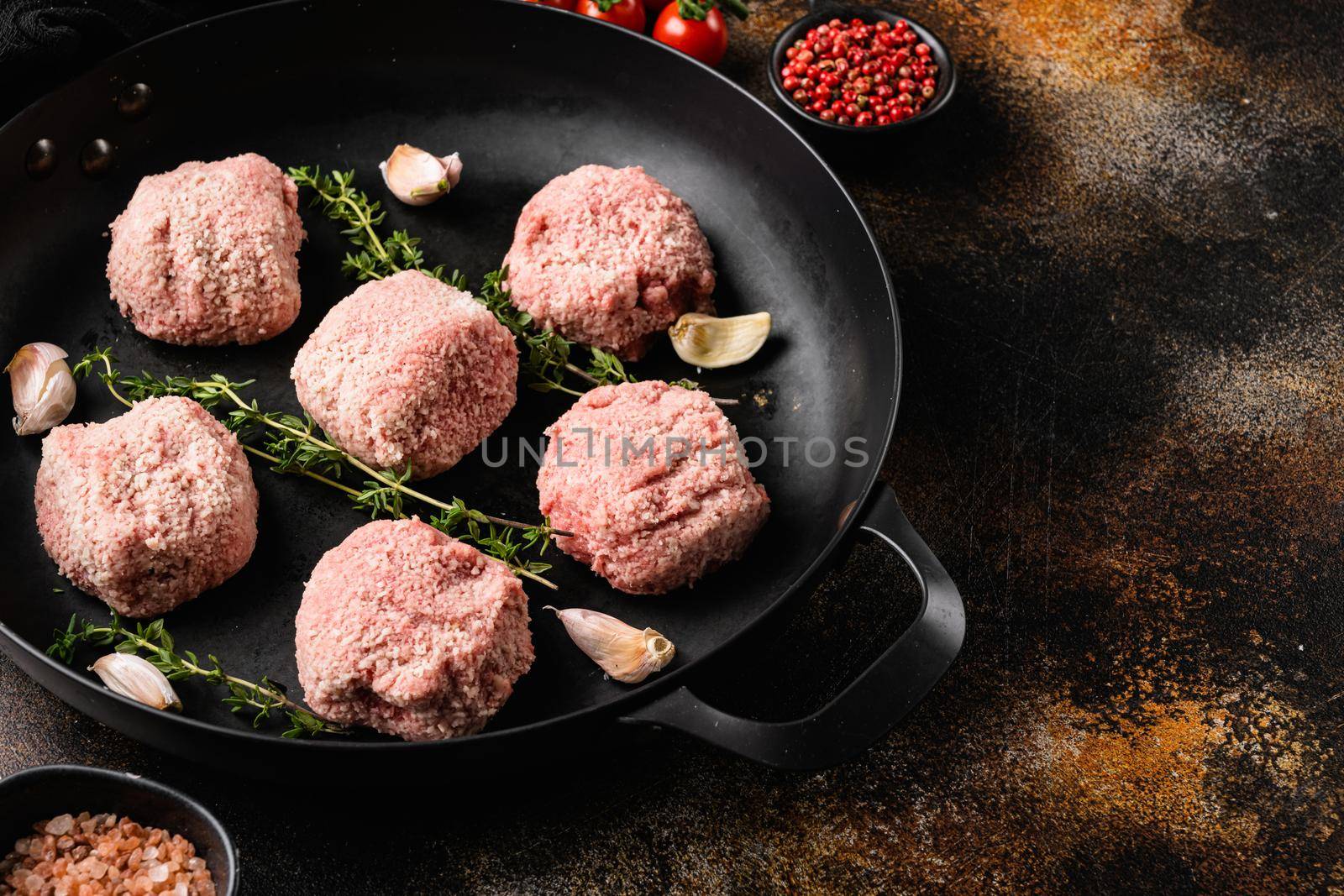 Meatball patties from minced meat, on old dark rustic table background, with copy space for text by Ilianesolenyi