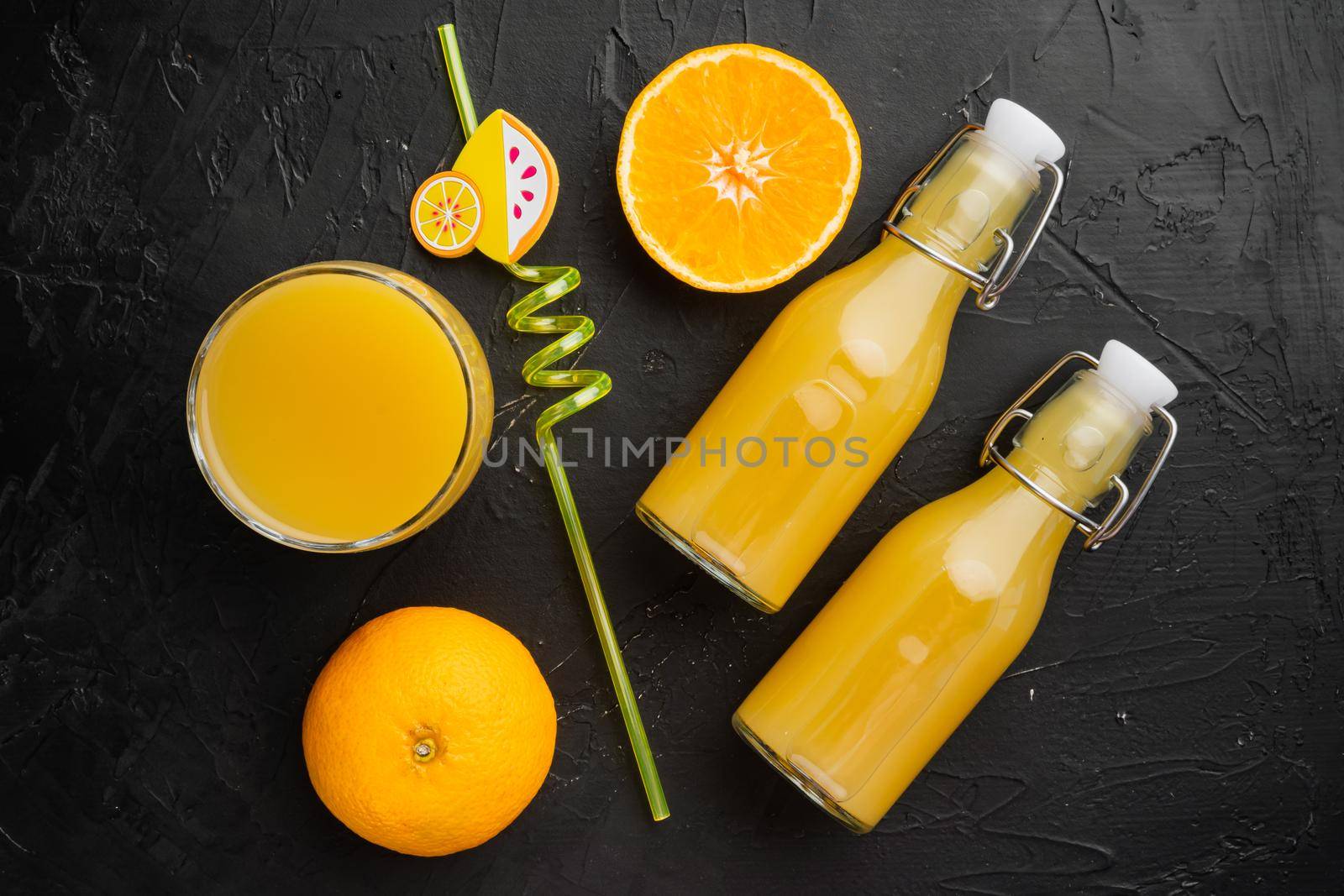 Fresh orange juice set, on black dark stone table background, top view flat lay
