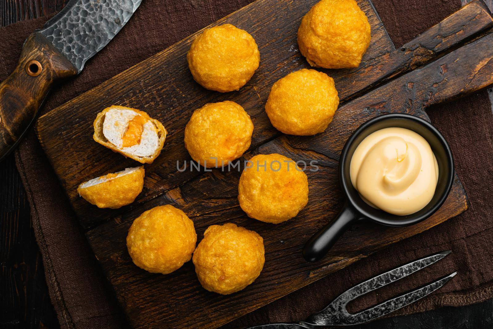 Breaded chicken fillet and batter, on old dark wooden table background, top view flat lay