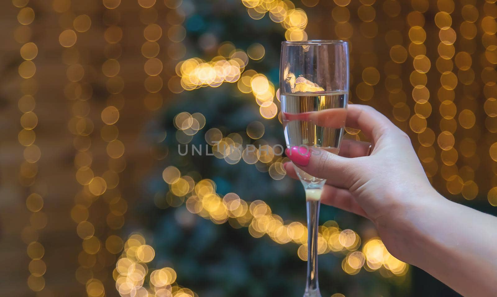 Girl on Christmas background with champagne. Selective focus. by yanadjana