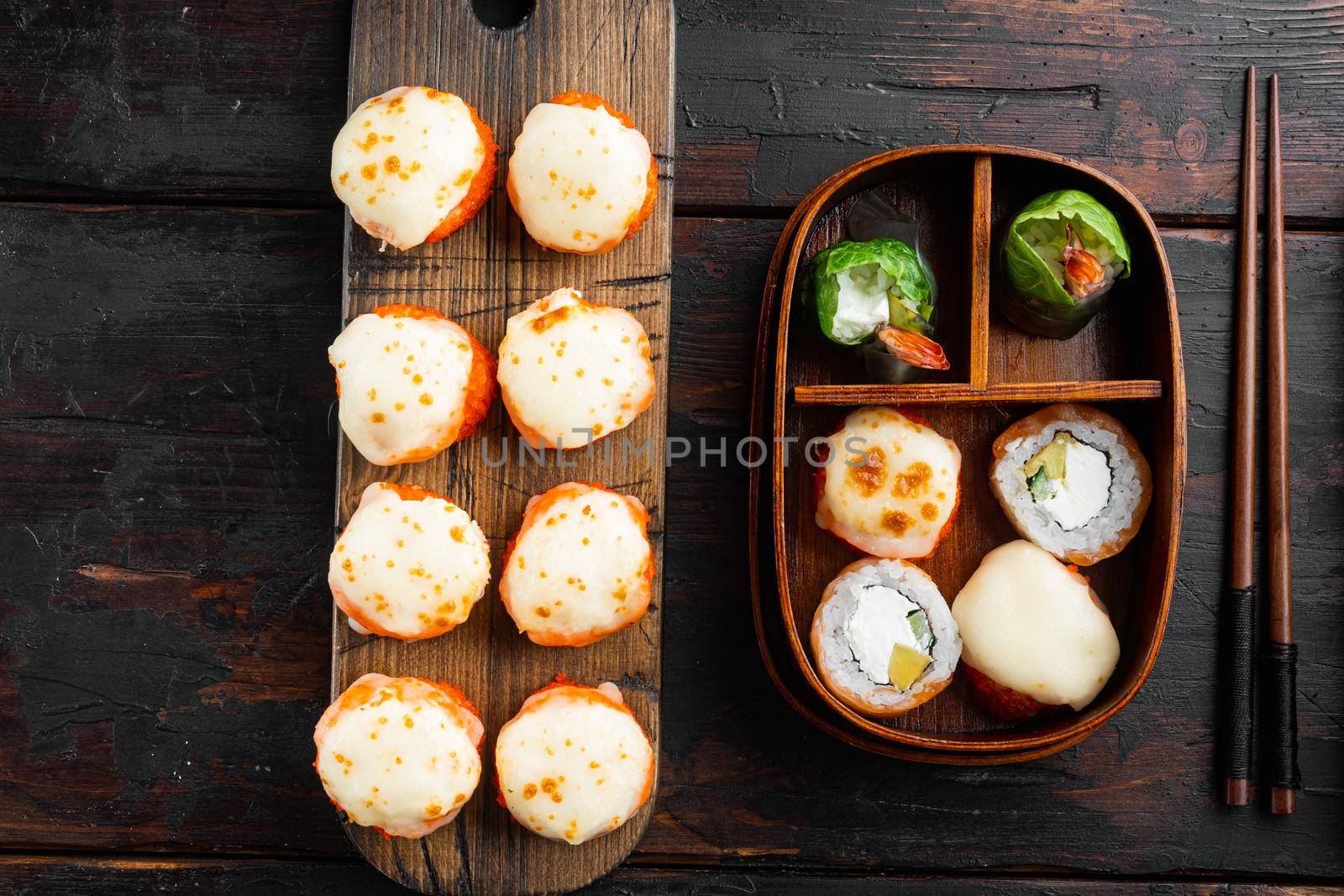 Fresh Sushi rolls with wasabi and ginger, on old dark wooden table background, top view flat lay by Ilianesolenyi