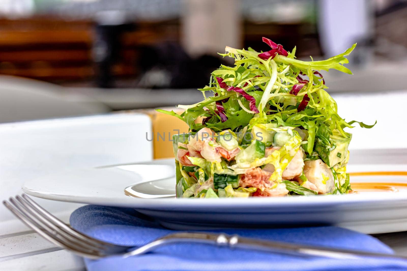 Layer Salad with Shrimps, Crab and Avocado in Luxury Restaurant by Milanchikov