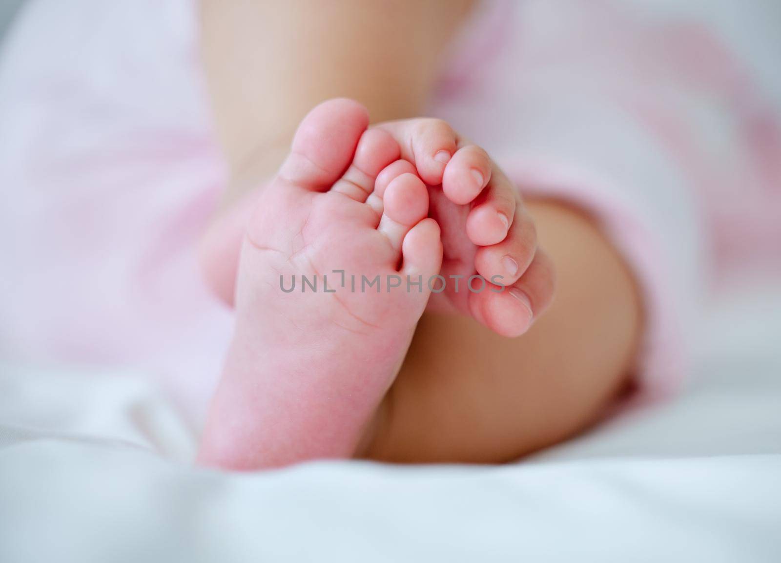 What do babies dream of. Cropped shot of a little babys feet as they sleep. by YuriArcurs