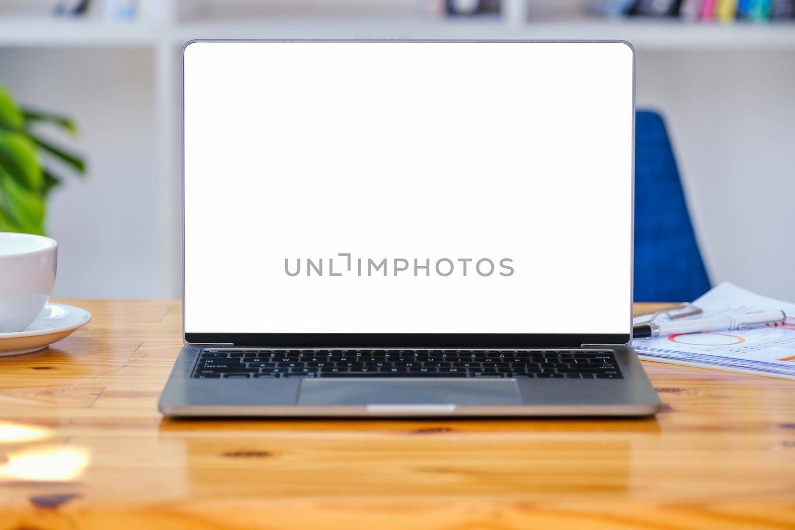 A white screen computer on a wooden table can carry text messages or images on a blank screen. by Manastrong