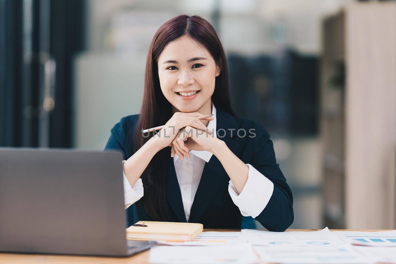Business Finance audit tax Concept. Portrait of Asian happy Businesswoman smiling and working at office. by itchaznong