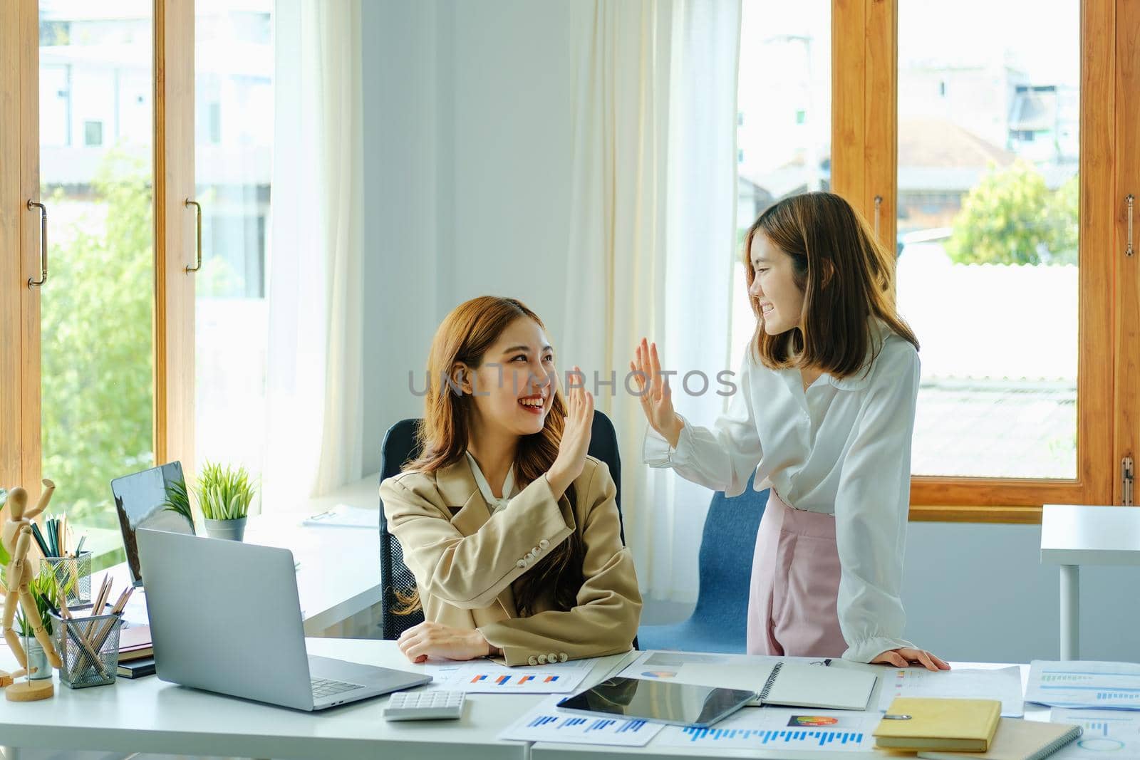 Young businesswoman collaborate with partners to increase their business investment network for Plans to improve quality next month in their office. agreement concept. by Manastrong