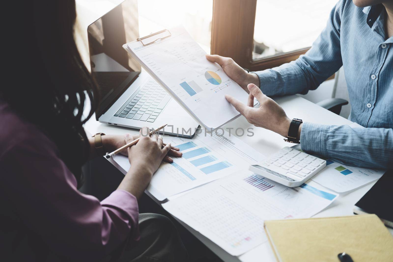 teamwork concept, consulting, portrait of male economist holding budget papers finance and investment Discuss and plan finances with a female marketer adviser in the conference room.
