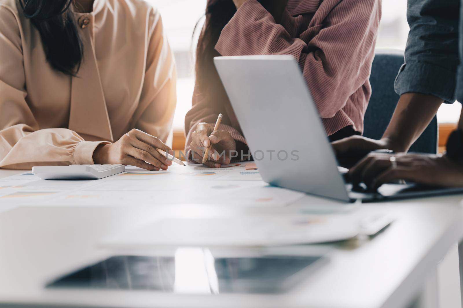Group of business people working at workplace. Business team hands at working with financial plan, meeting, discussion, brainstorm with tablet on office desk