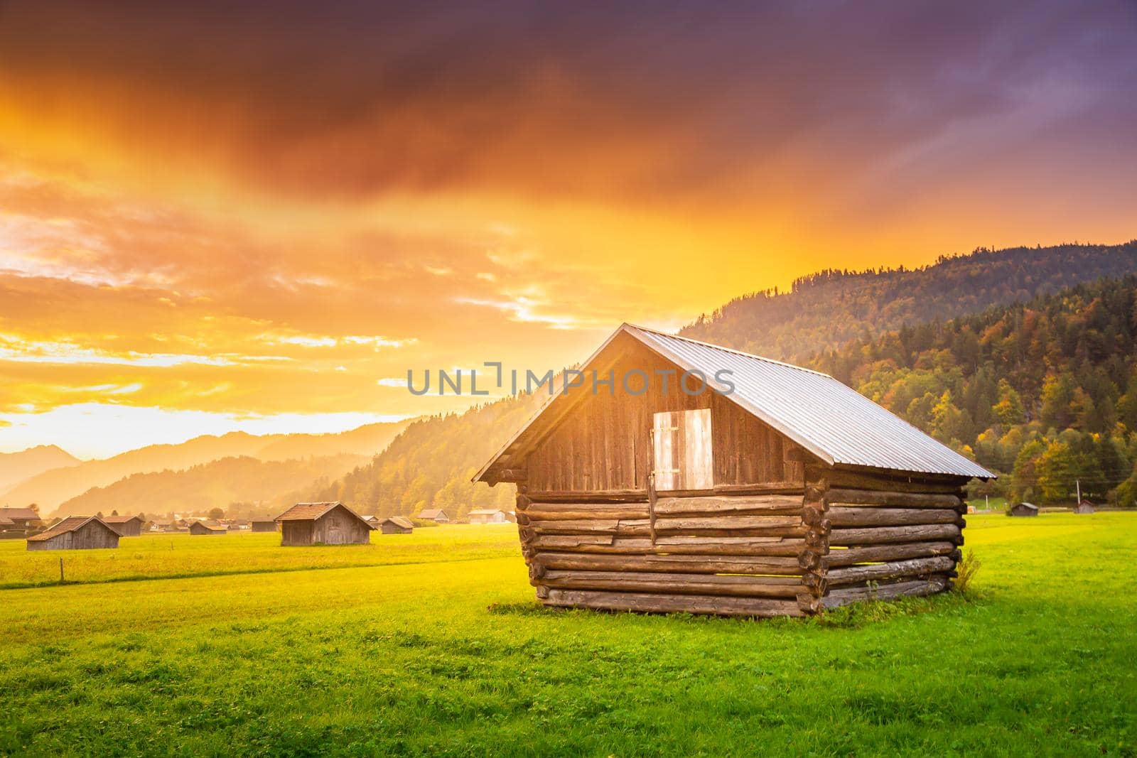 Garmisch-Partenkirchen countryside barns for agriculture at dramatic sunset - Bavarian alps, Germany