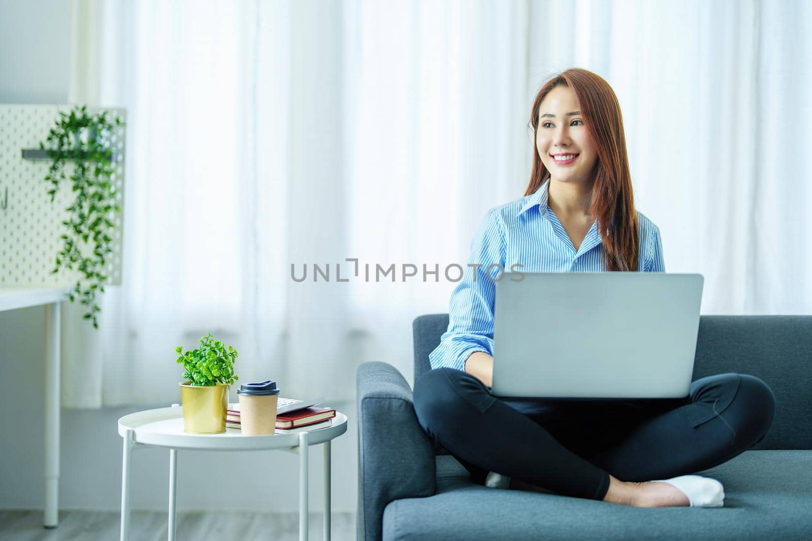 internet learning, online shopping, selling, meeting, information searching, Portrait of young Asian woman showing smiling face while using tablet to work at home. by Manastrong