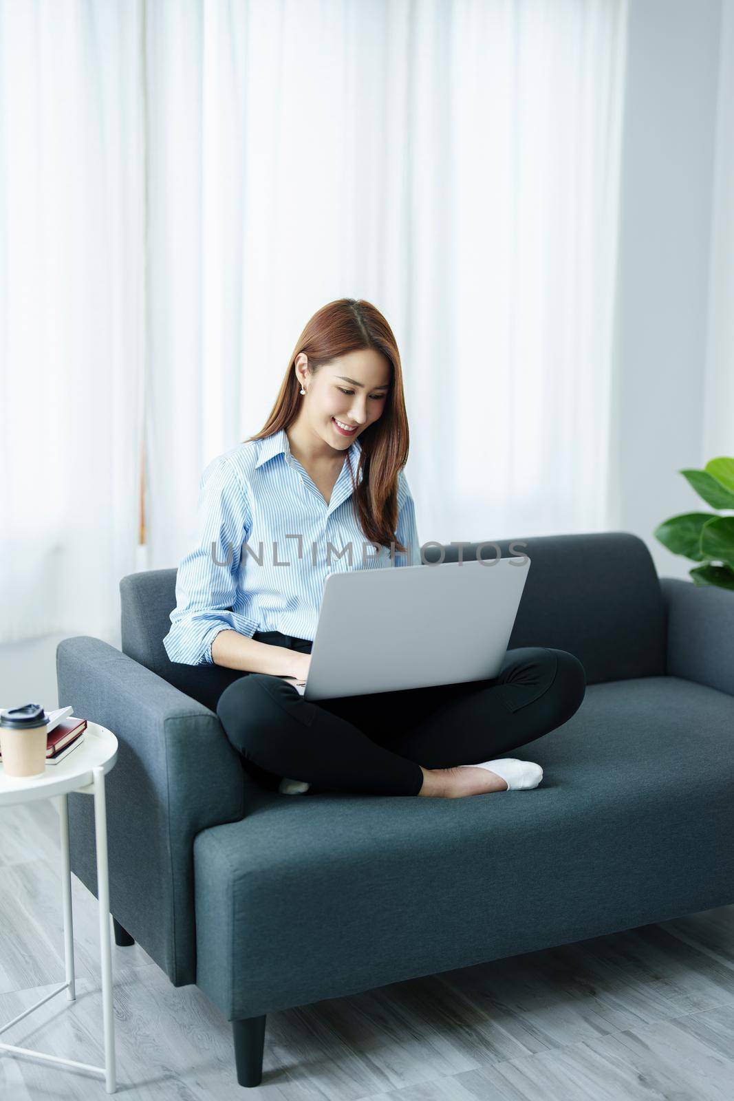 internet learning, online shopping, selling, meeting, information searching, Portrait of young Asian woman showing smiling face while using tablet to work at home