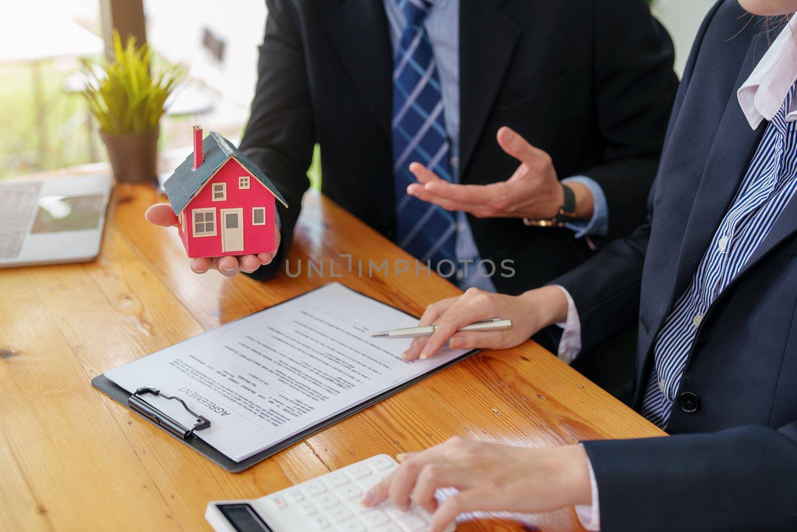 Guarantees, mortgages, signing, interest on loans, real estate agents are making agreements with customers to buy houses and land and sign contract documents by Manastrong