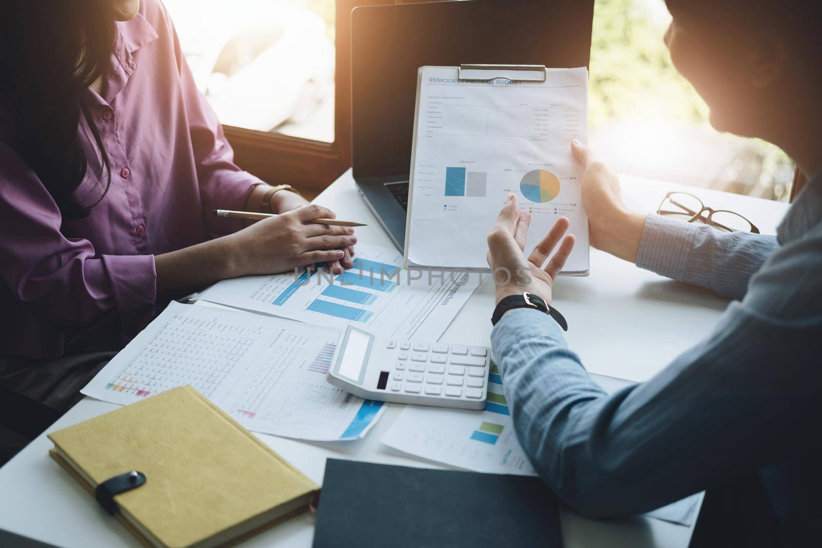 teamwork concept, consulting, portrait of male economist holding budget papers finance and investment Discuss and plan finances with a female marketer adviser in the conference room by Manastrong